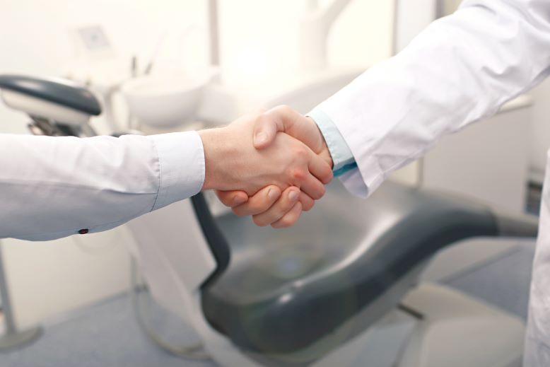 patient and dentist shaking hands