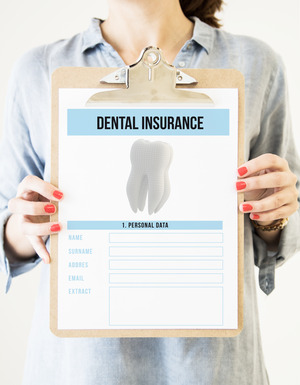 Woman holding clipboard with dental insurance form